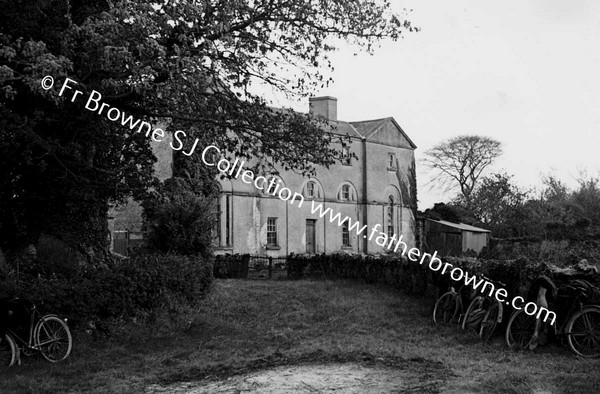 HOUSE WITH BICYCLES IN FOREGROUND